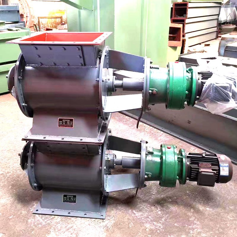 Two rotary valves stacked on the warehouse floor in a factory setting, showcasing their design and readiness for installation in material handling systems