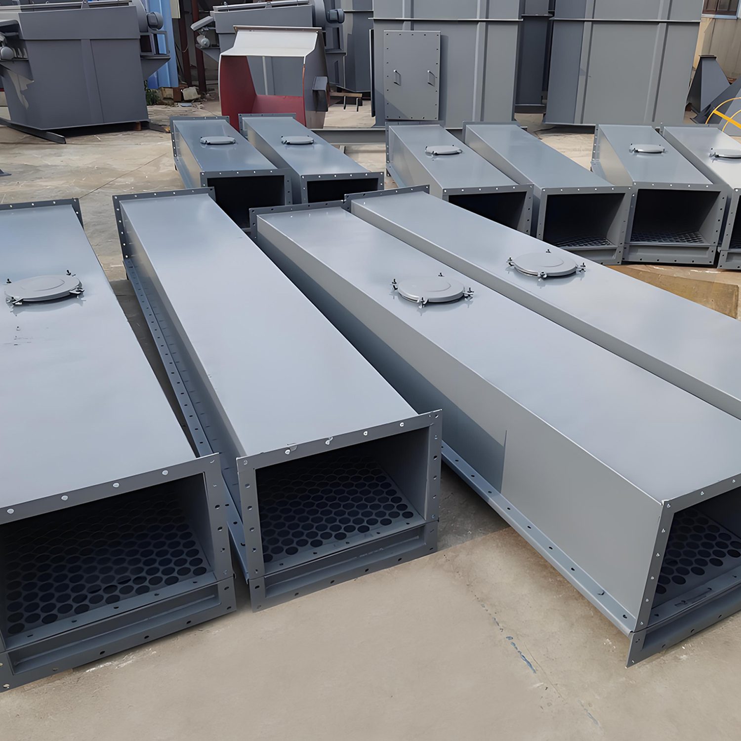 Several large metal boxes are stacked together to demonstrate the application of the air slide conveyor system.