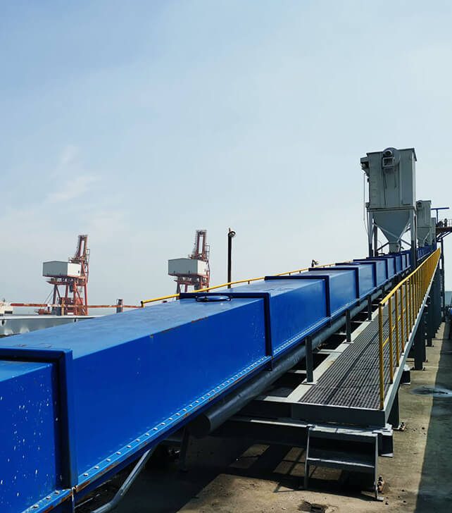 A conveyor belt equipped with blue and yellow rails, part of a Cement Air Slide Conveyor for streamlined operations.