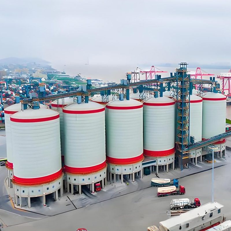 A vast industrial complex characterized by numerous cement silos, representing a key component of the cement production process.