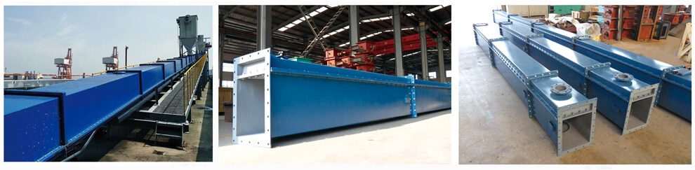 A blue metal air slide conveyor sits on the concrete floor, showcasing its sturdy design and efficient functionality for transporting materials in the industrial setting.