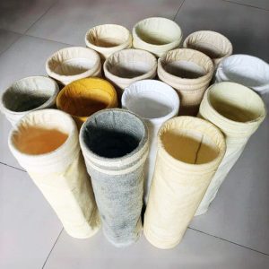 Different types of filter cloths arranged, highlighting a white and yellow dust collector filter bag in the selection.