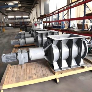 A collection of industrial machinery, including a star ash discharge valve, arranged on pallets in a warehouse setting.