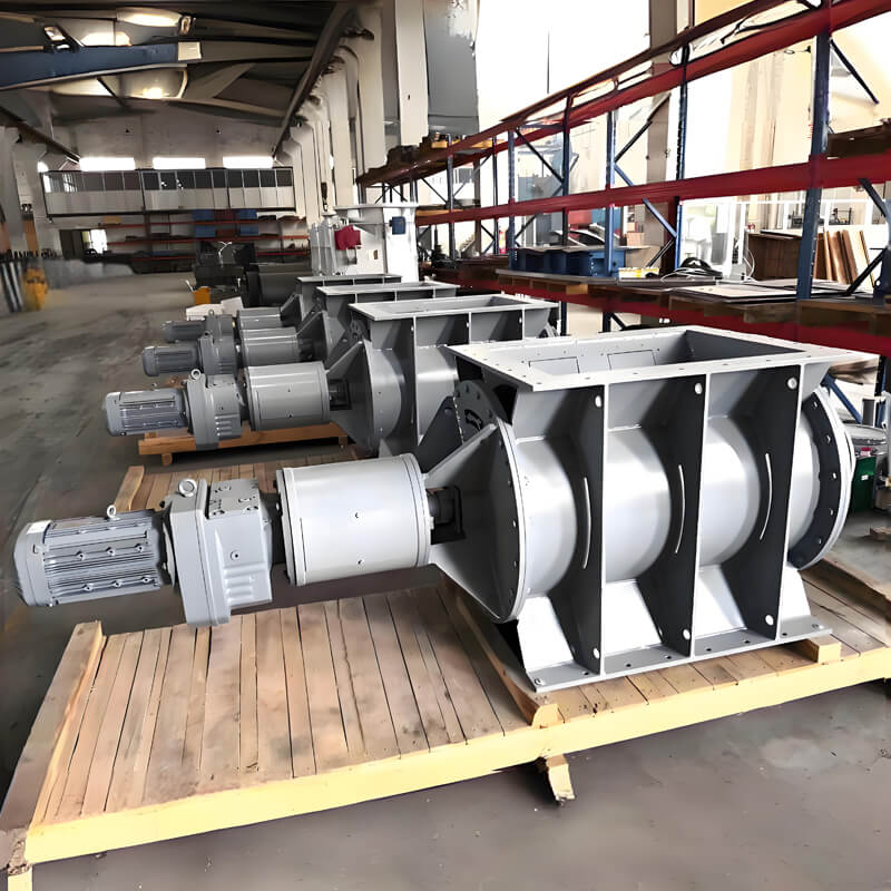 A collection of industrial machinery, including a star ash discharge valve, arranged on pallets in a warehouse setting.