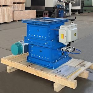 A blue pneumatic flow control gate placed on a pallet inside a warehouse.