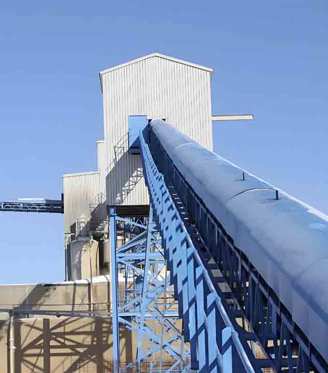 Bucket elevator system designed for vertical material transport, showcasing buckets attached to a vertical conveyor belt